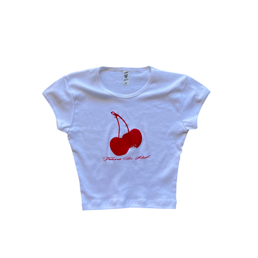 White crop top with red cherry graphic and text on a white background
